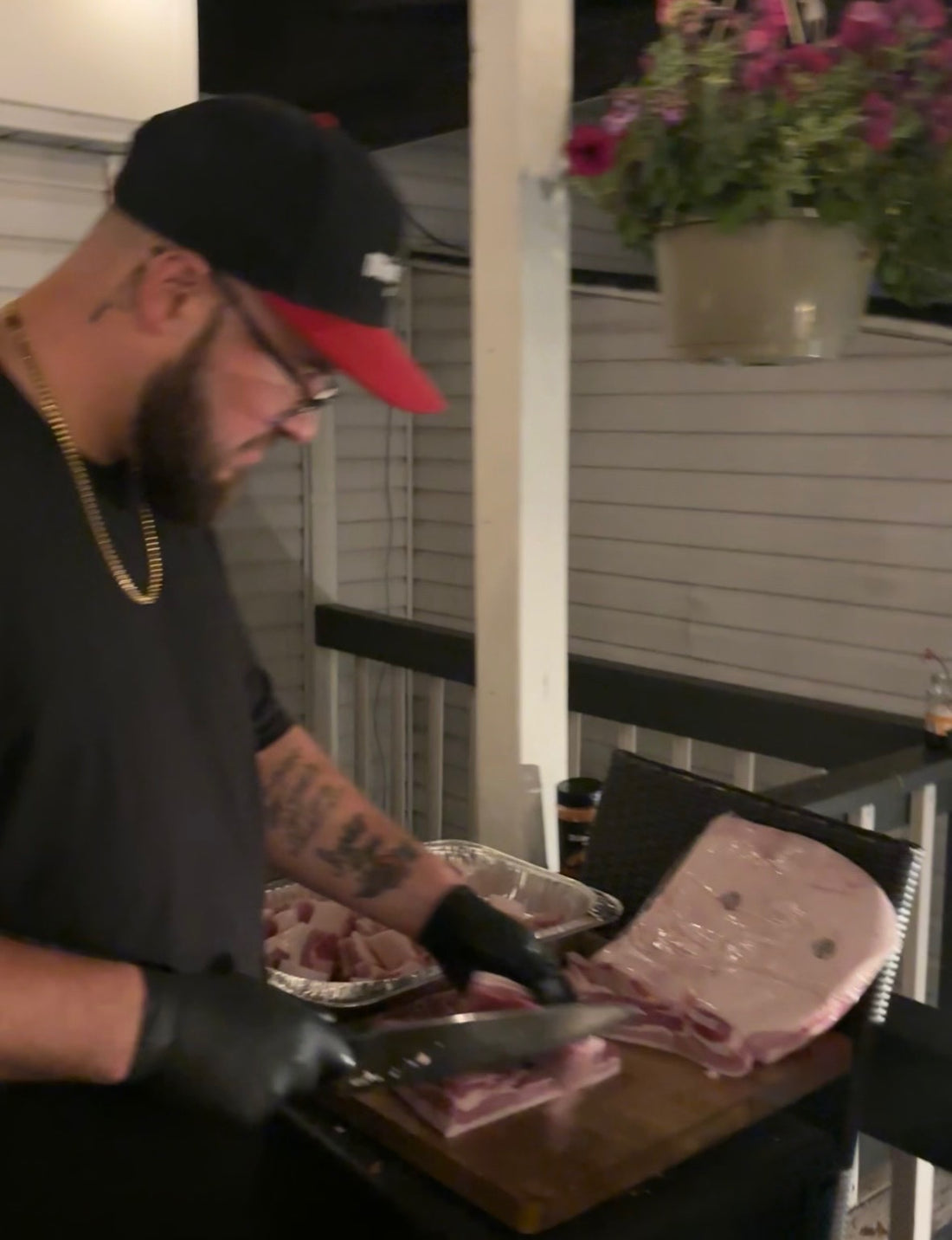 Chris Apple of White Bulls BBQ cutting up meat