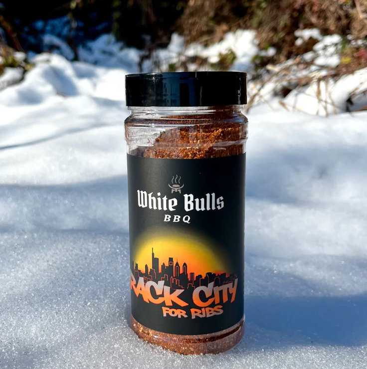 Jar of White Bulls BBQ rub in the snow
