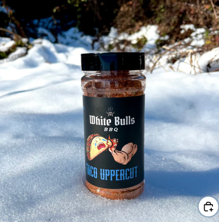 Jar of 'White Bulls BBQ Taco Uppercut' spice mix on a snowy background